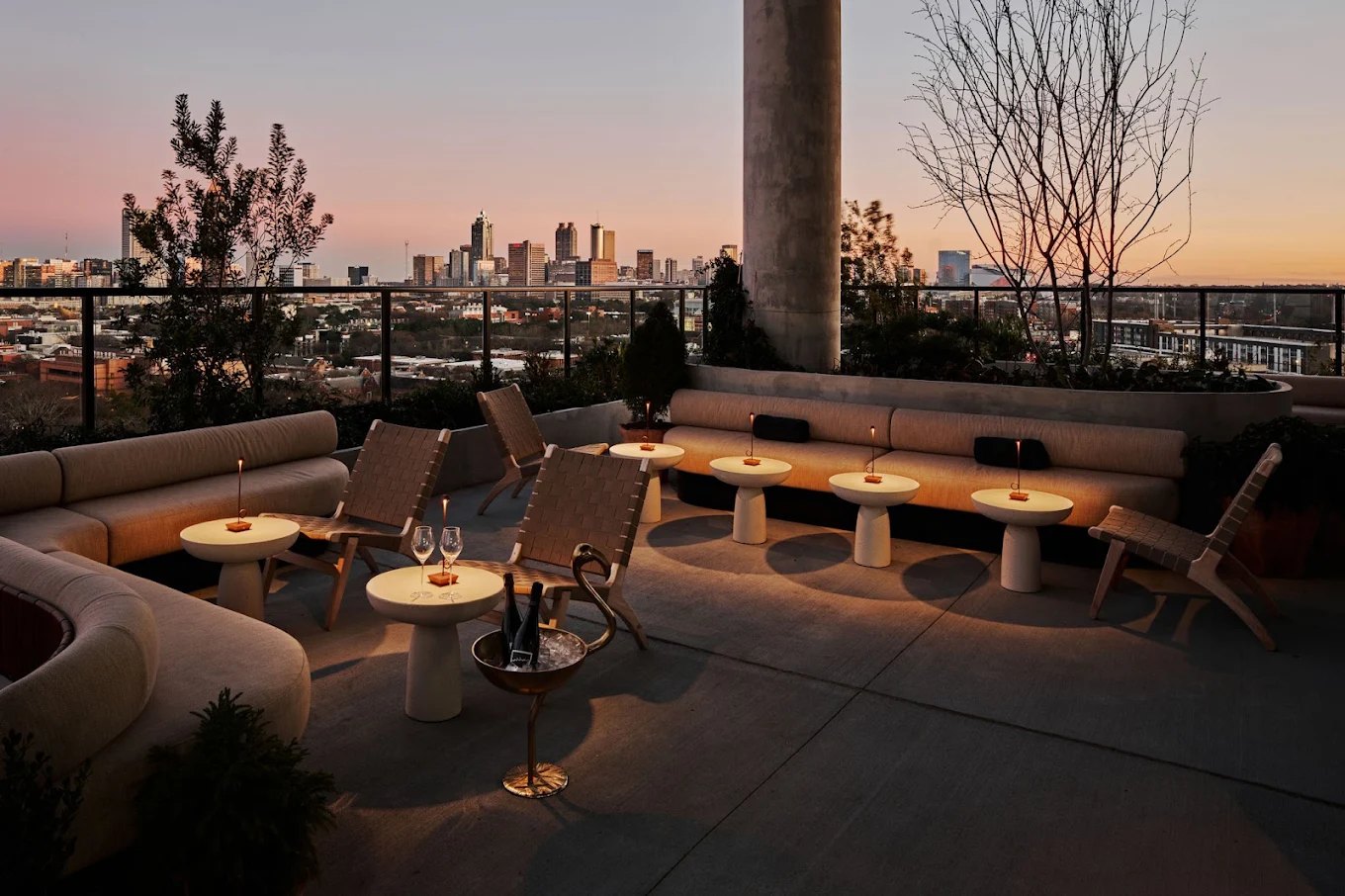The rooftop at Rabbit Ears at dusk, looking at the Atlanta skyline